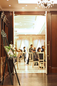 People sitting in restaurant seen through doorway