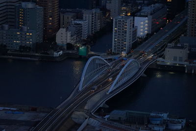 High angle view of river amidst buildings in city at dusk