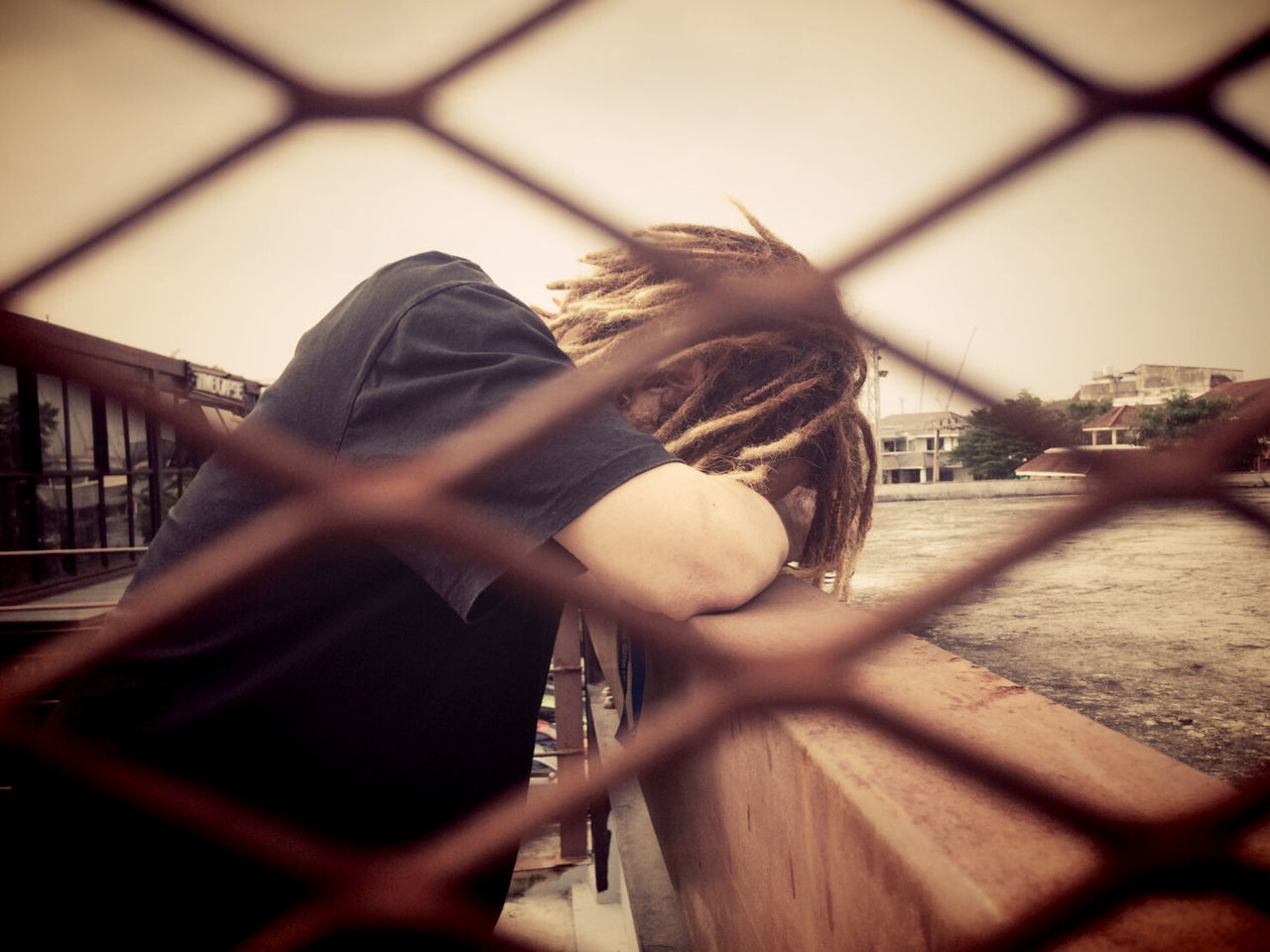 focus on background, one person, real people, lifestyles, bridge - man made structure, day, leisure activity, built structure, outdoors, young adult, architecture, young women, building exterior, sky, people