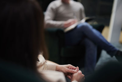 Female patient wringing hands at therapy session