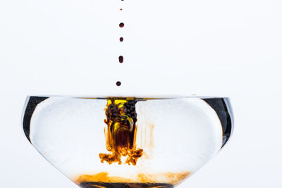 Close-up of wine glass against white background
