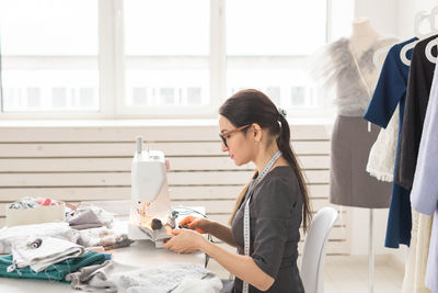 Side view of young woman sitting in office