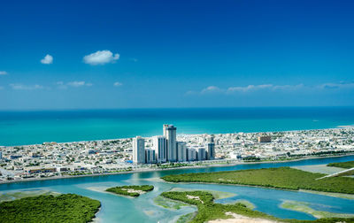 Scenic view of sea and buildings against sky