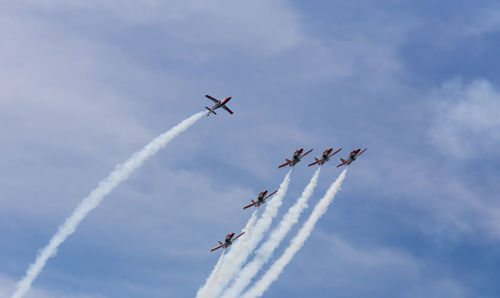 Low angle view of airshow against sky