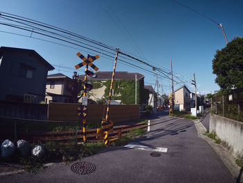 Road amidst buildings against sky