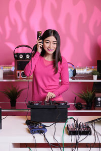 Portrait of young woman using laptop on table