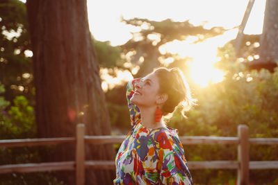 Side view of a girl looking through tree