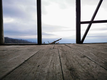 Surface level view of wooden pier against sky