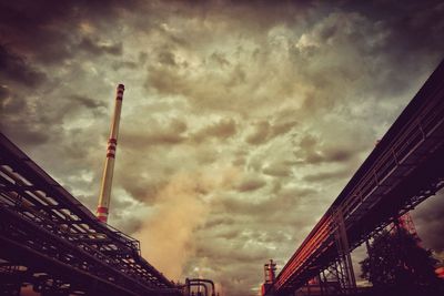 Low angle view of buildings against cloudy sky