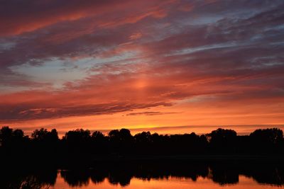 Scenic view of lake against orange sky