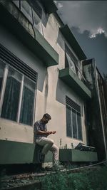 Woman sitting outside building