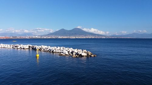 Scenic view of sea against blue sky