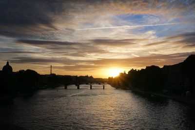 Scenic view of river against sky at sunset