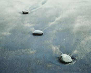 High angle view of stones on sand