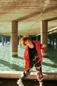 Mixed heritage asian-spanish young female dancing with red jacket