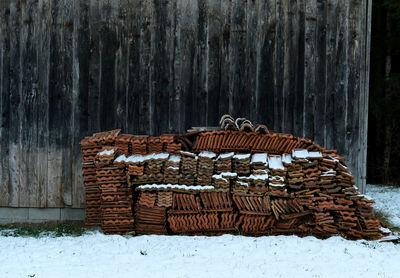 Stack of logs on snow covered land