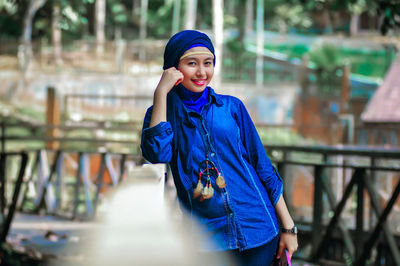 Portrait of young woman standing outdoors