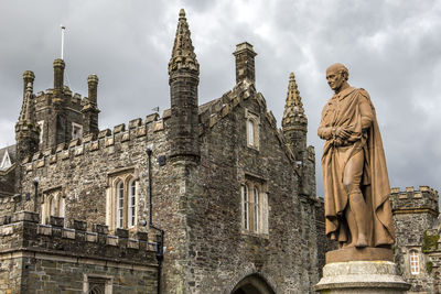 Low angle view of statue against building