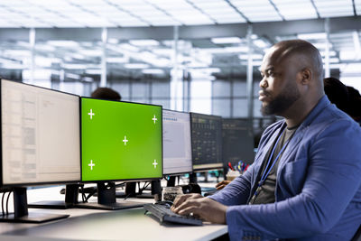 Side view of man working in office
