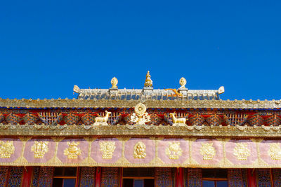 Low angle view of building against blue sky