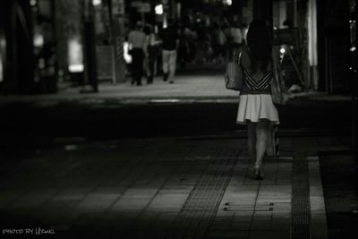 Full length of young woman standing at night