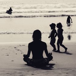 Two people sitting on beach