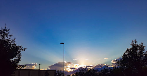 Low angle view of street against blue sky