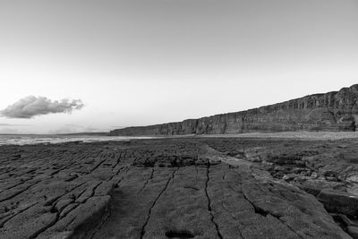 Scenic view of arid landscape against sky