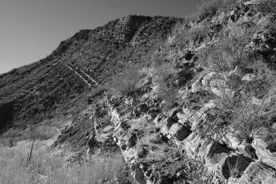 Low angle view of rock formation on mountain against sky