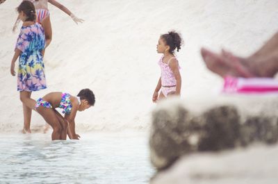 Rear view of people enjoying in water