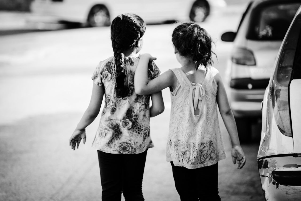 REAR VIEW OF MOTHER AND DAUGHTER IN HANDS