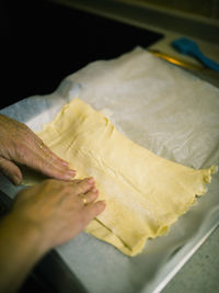 High angle view of hand holding cutting board