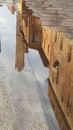 Reflection of building in puddle