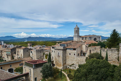 Buildings in town against sky