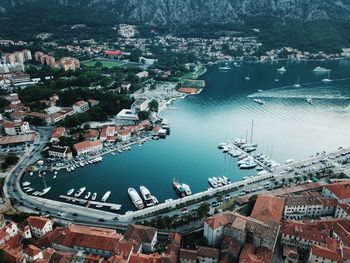 High angle view of illuminated city by sea