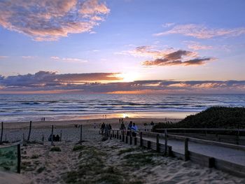 Scenic view of beach against sky during sunset