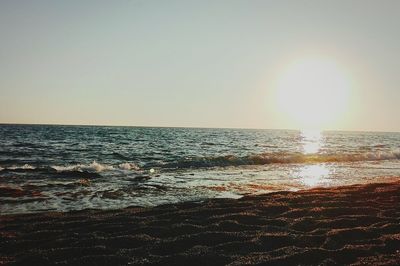 Scenic view of sea against clear sky during sunset