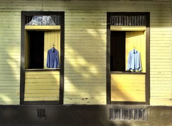 Shirts hanging on wooden windows