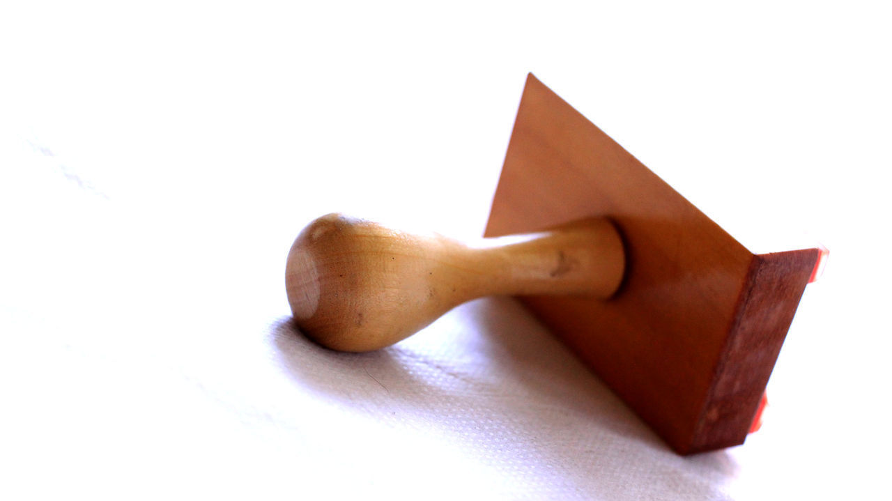 CLOSE-UP OF STUFFED TOY ON PAPER AGAINST WHITE BACKGROUND