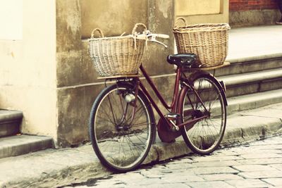 Bicycle parked against brick wall