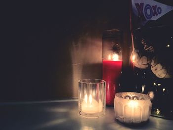 Close-up of lit tea light candles on table