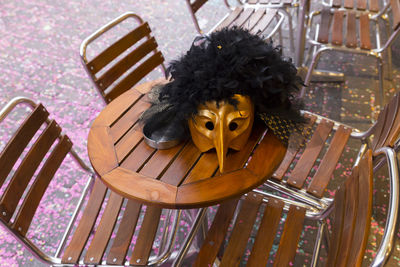 High angle view of mask on table at sidewalk cafe