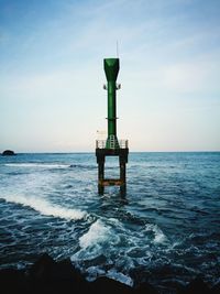 Lifeguard hut in sea against sky