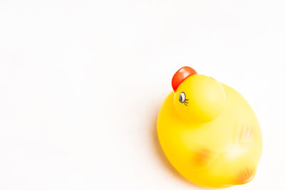 Close-up of yellow balloon against white background