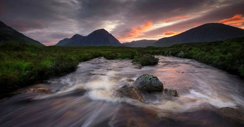 Scenic view of mountains against cloudy sky