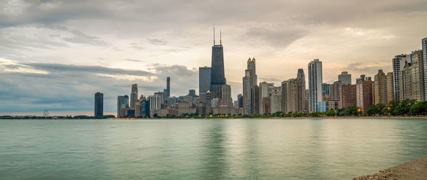 City at waterfront against cloudy sky ,chicago city,usa