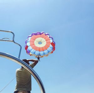 Low angle view of umbrella against blue sky