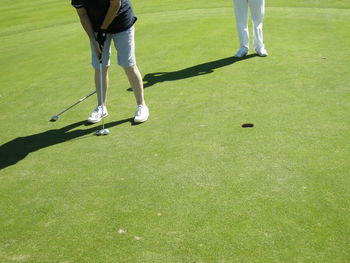 Low section of man standing on golf course