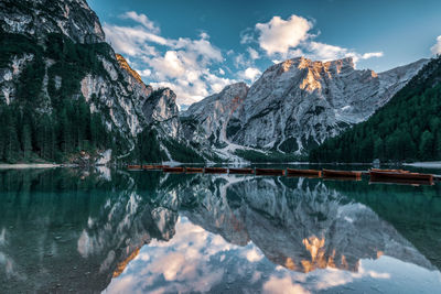 Scenic view of lake and snowcapped mountains against sky