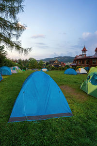 Tent on field against cloudy sky